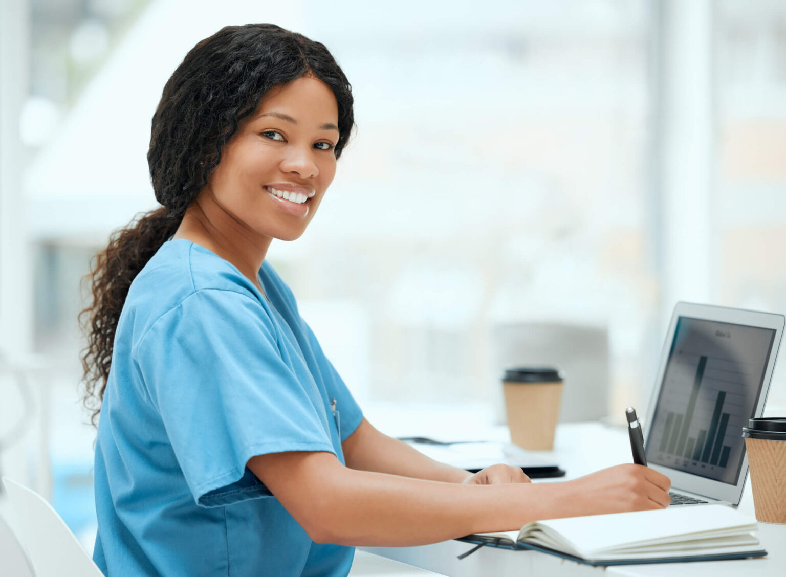 Shot of a young female doctor using a laptop while working at a hospital